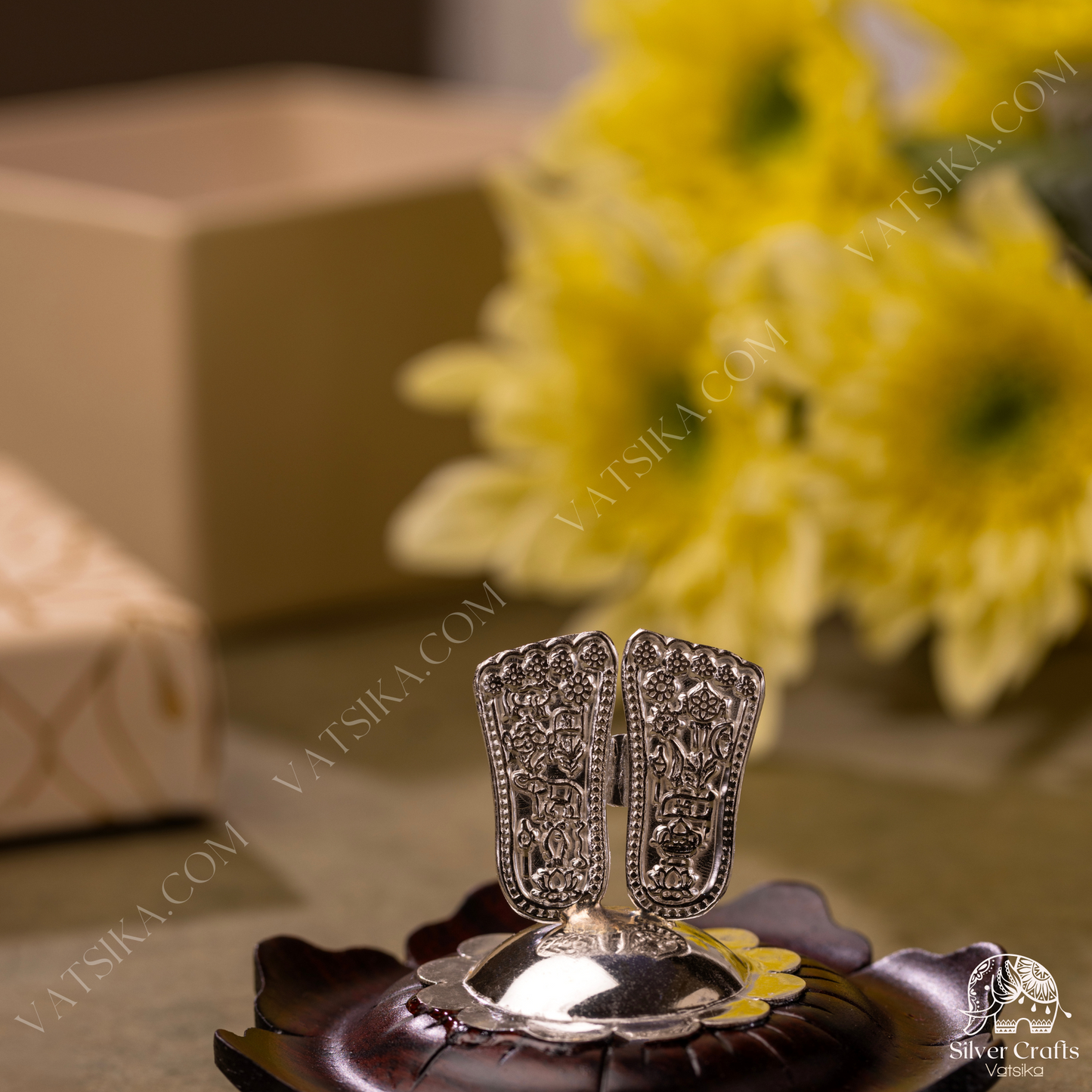 Silver Sri Vishnu Padam encased on a lotus flower