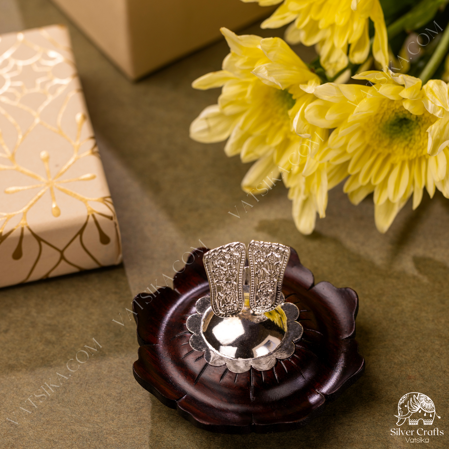 Silver Sri Vishnu Padam encased on a lotus flower