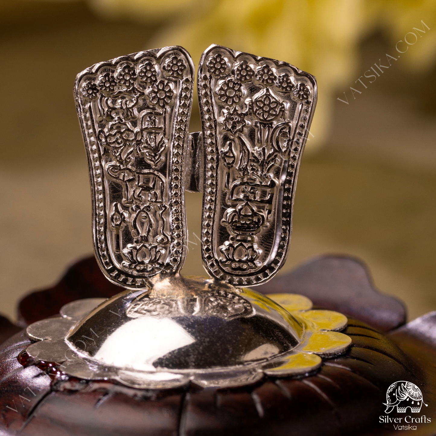 Silver Sri Vishnu Padam encased on a lotus flower